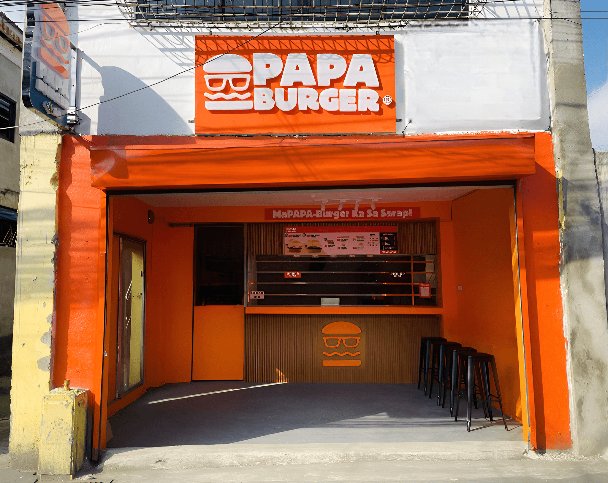 The service window of a Papa Burger branch, open to the street.